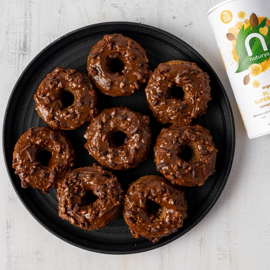 vegan and gluten free protein donuts topped with chocolate and sprinkled with chocolatey nibs